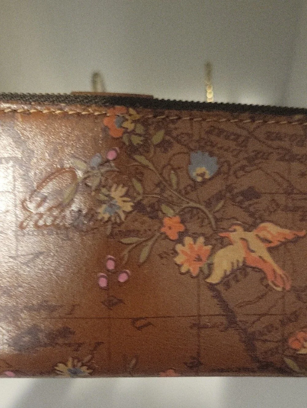Brown leather Patricia Nash bifold wallet featuring an artistic vintage map back